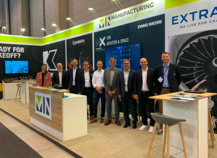 Group photo of the exhibitors at a joint booth organized by the Manufacturing Innovation Network (MIN) at ILA 2026 in Berlin.