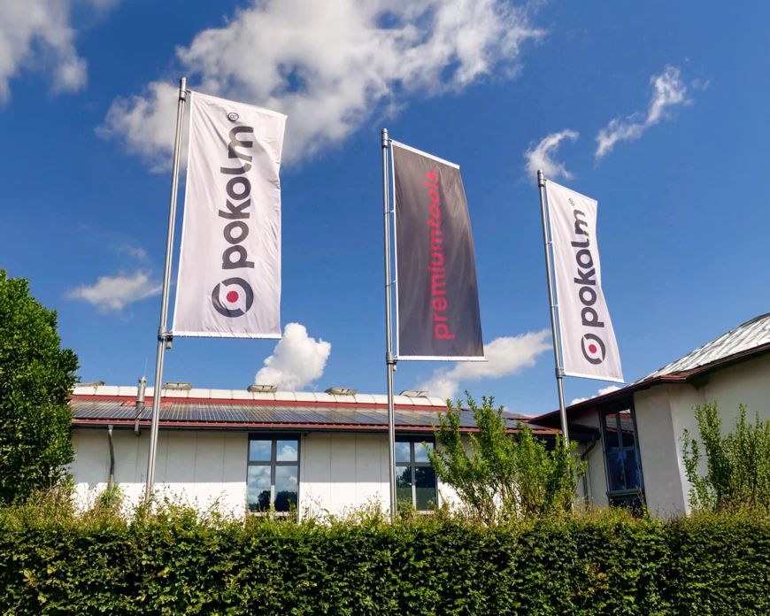 A photo of the advertising flags in front of the main building of Pokolm in Harsewinkel, Germany.